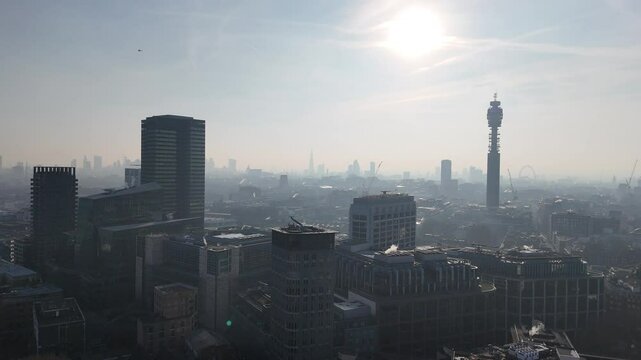 London skyline and BT tower silhouetted against Low rising sun aerial view