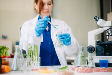 Scientist testing food samples in lab with microscope, vegetables, and meat for safety, nutrition, and biotechnology