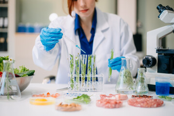 Scientist testing food samples in lab with microscope, vegetables, and meat for safety, nutrition, and biotechnology