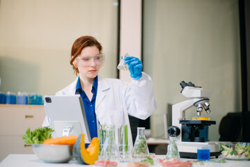 Fototapeta premium Scientist analyzing food samples in modern lab with advanced equipment for safety, nutrition, and biotechnology research.