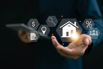 Real estate investment concept . Businessman use laptop with house icon for analyzing mortgage loan...