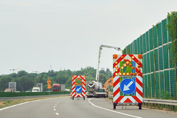 Traffic lane closed due to roadwork ahead signs