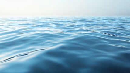 A calm, reflective water surface with gentle ripples, creating a smooth and serene texture. The water is clear and glossy, reflecting the soft light of the sky,