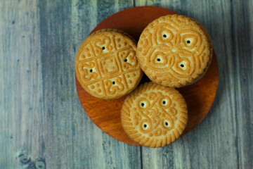 stack of delicious almond biscuits on a wooden board