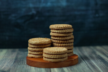stack of delicious almond biscuits on a wooden board