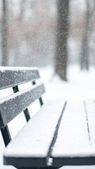 serene park bench covered in fresh snow, surrounded by winter landscape. gentle snowfall creates peaceful atmosphere