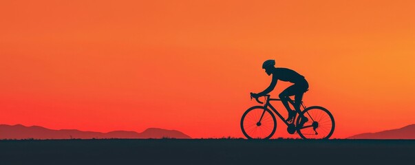 Obraz premium A cyclist rides against a stunning sunset, showcasing determination and grace.
