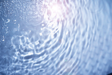 Bubbles and seething water in the light of sunlight.Blue water texture.