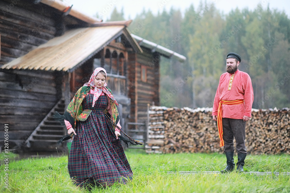 Wall mural Traditional Slavic rituals in the rustic style. Outdoor in summer. Slavic village farm. Peasants in elegant robes.