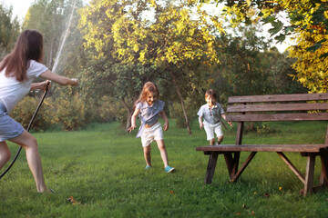 Children on a walk in the summer. Children indulge in the country. Laughter and splashing water.