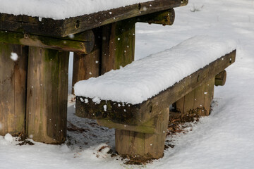 A snow-covered bench.