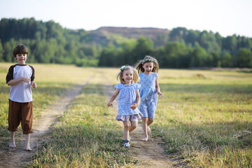Children walk in the summer in nature. Child on a sunny spring morning in the park. Traveling with children.
