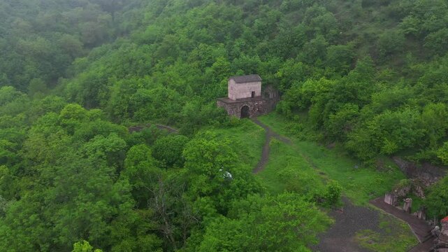 4K aerial drone footage of Vahanavank Monastery near Kapan, on the slopes of Mount Khustup in Syunik (Zangezur), Armenia. A historic medieval monastery surrounded by lush green forests and wild nature