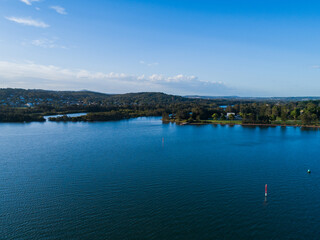 The Five Islands and Cockle creek flowing into blue water of Cockle bay seen from aerial perspective