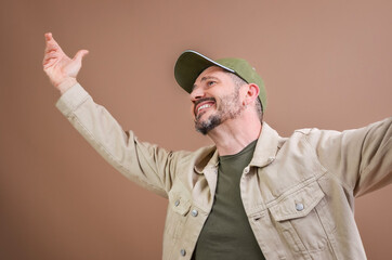 Enthusiastic man raising arms and smiling, feeling freedom and happiness