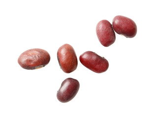 A bunch of red beans are spread out on a white background
