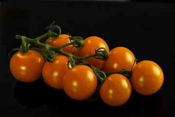 Yellow sweet tomato on the branch