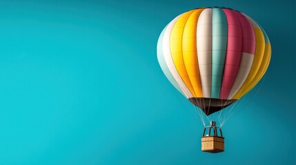 Fototapeta premium Colorful hot air balloon floats against a vibrant blue sky.