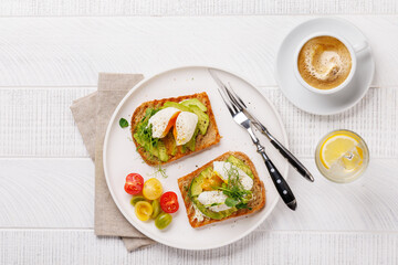 Delicious avocado toasts topped with perfectly cooked poached eggs
