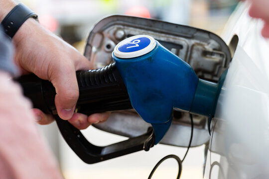 Service station fuel pump detail of nozzles for unleaded 91 petrol filling up car