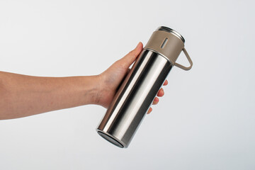 Bottle tumbler aluminium water glass and hand isolated white background.