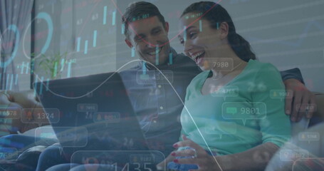 Image of data processing on charts over happy caucasian couple using laptop at home