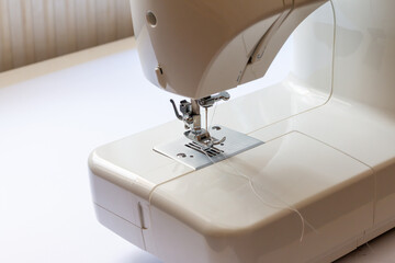 Close-up of sewing machine and sewing needle in fashion design studio