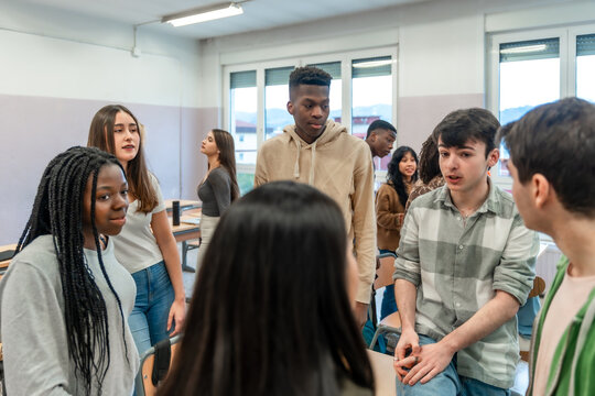 High school students interacting during break time in classroom