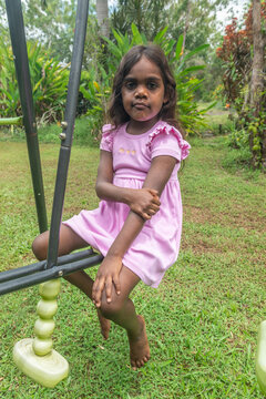 4 year old aboriginal girl holding sore elbow