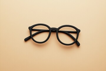 Fototapeta premium Black Eyeglasses Resting on a Beige Colored Background
