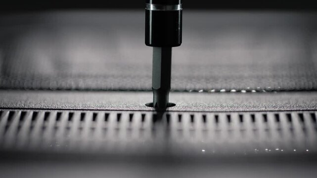 Manual screwdriver tightening a cross-head screw on a laptop casing, highlighting precision, hardware repair, and computer maintenance