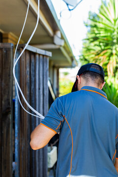 Electrician running wires and cables for solar power system install connection in residential home