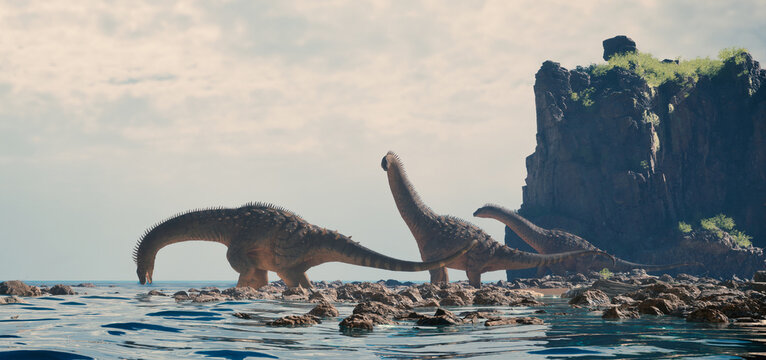 Large dinosaurs traverse rocky coastline near ocean under cloudy sky at a serene time of day