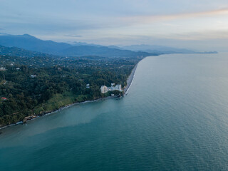 Aerial view of The Batumi from afar, is on the Black Sea cost. Chakvi beach. Adjara. Georgia. Green city by the sea and mountains