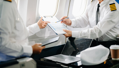 Mature commercial male pilot Beautiful middle aged woman airplane captain instructor has a meeting,...