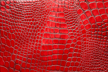 A close-up of vibrant red crocodile leather, showcasing its unique scales and texture, perfect for fashion and luxury design themes