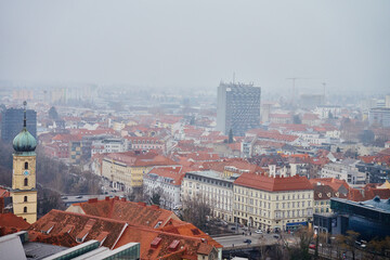 Graz cityscape on foggy day. Panoramic view of Graz, Austria with historical architecture. Streets...