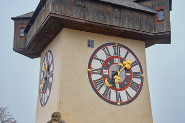 Famous Grazer Uhrturm clock tower with golden hands in Graz, Austria