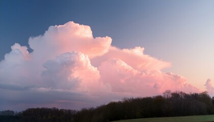 dreamy pastel sky with pink and white fluffy clouds in soft sunset light