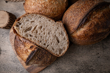 Golden-Crusted Artisan Sourdough Bread on a Rustic Wooden Table.