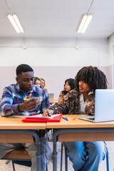 High school students collaborating on project in classroom