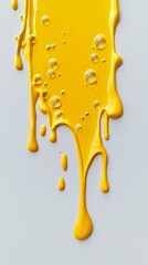 Yellow paint dripping down a white canvas with bubbles, abstract art concept