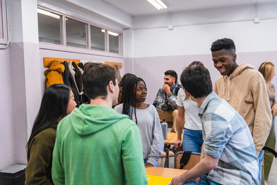 High school students chatting and learning together in classroom
