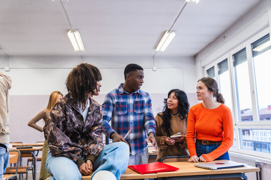 High school students collaborating on a project in classroom