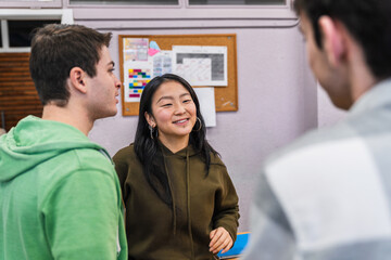 High school students chatting together in classroom