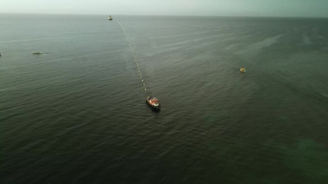 Fiber optic cable installation off Margarita Island, Venezuela, with boats and teamwork
