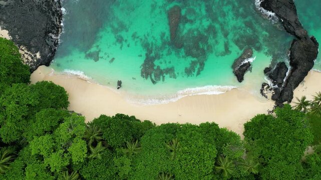 Top down drone shot above the Praia Cafe paradise beach on Rolas island, Sao Tome