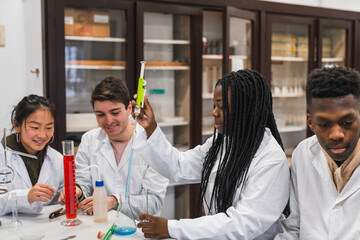 High school students conducting chemistry experiment in laboratory