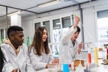 High school students performing chemistry experiment in laboratory