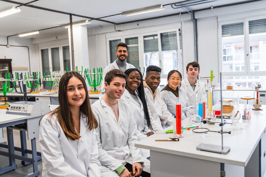 High school students smiling during chemistry lesson in laboratory